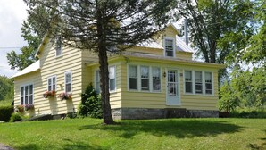 A yellow house with a stone foundation, large windows, and a chimney. - Unique FarmStay Experience in The Catskills! (Durham)