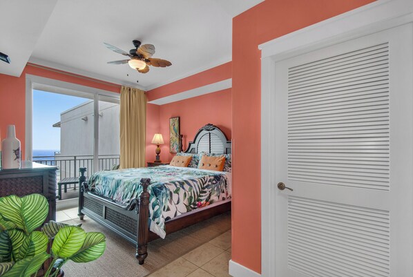 A bedroom with a bed, a ceiling fan, a window, and a door. - Waterscape B602 ~ Oceanfront 3BR ~ Unbelievable Views! (Fort Walton Beach)