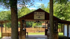 A wooden cabin with a sign reading 'Big Jack's River Shack.'