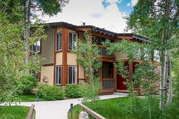View of the condo (1st floor) nestled in the trees.