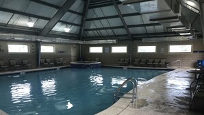 An indoor swimming pool with a tiled floor, a hot tub, and multiple windows providing natural light. - 🏖 Beach front 3 bedroom 2 bath and 3 balconies corner unit extra balconies (Gulf Shores)