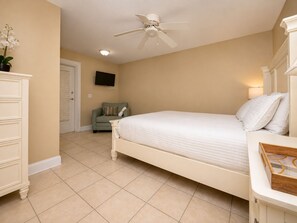 A bedroom with a bed, a dresser, a television, and a ceiling fan. - Last Minute Rates, Beach Front Home, 3Beds, 3.5 Bath, Full Ocean View (Panama City Beach)