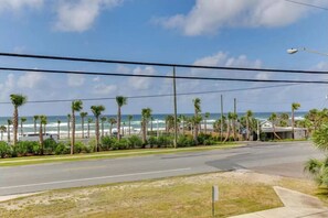 A coastal road with a view of the ocean and palm trees. - Last Minute Rates, Beach Front Home, 3Beds, 3.5 Bath, Full Ocean View (Panama City Beach)