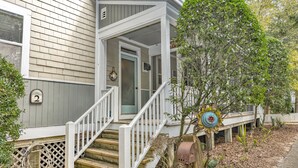 A house with a porch, a mailbox, and a number '2' sign. - Charming cottage in Sabal Palm with screened in porch and outdoor shower (Bald Head Island)
