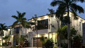A modern two-story residential building with a well-maintained lawn and palm trees. - DELRAY BEACH  Private Pool, Close To Sea (Delray Beach)