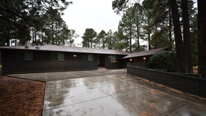 A modern house with a large driveway and a covered porch area. - Luxury Ranch House on Continental Golf Course, Great for families, Remodeled.  (Flagstaff)
