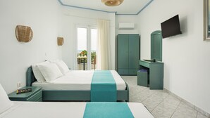 A bedroom with a bed, a desk, a television, and a wardrobe.