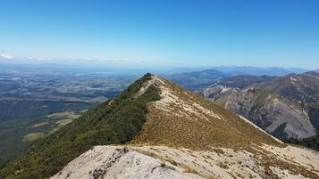A mountain peak with a clear view of the surrounding landscape.