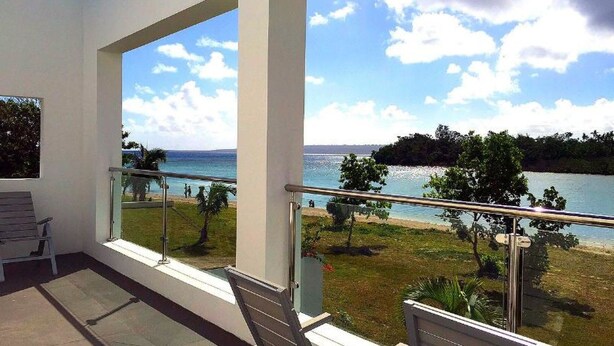 A balcony with a view of a lake and beach. - Paradise Point Views (Port Vila)
