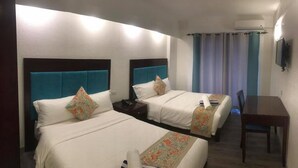 A hotel room with two beds, a desk, and a chair. - El Puerto Boracay (Boracay Island)