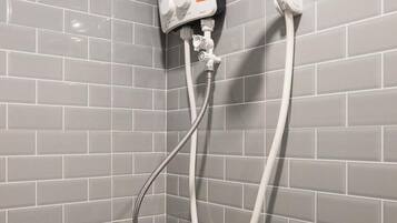 A shower with a handheld showerhead and a wall-mounted control panel.