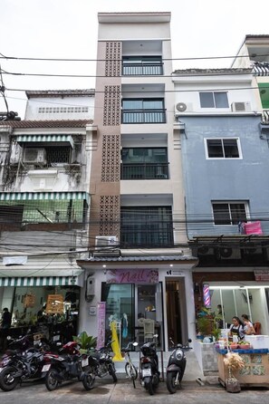 A multi-story building with a storefront at the ground level.