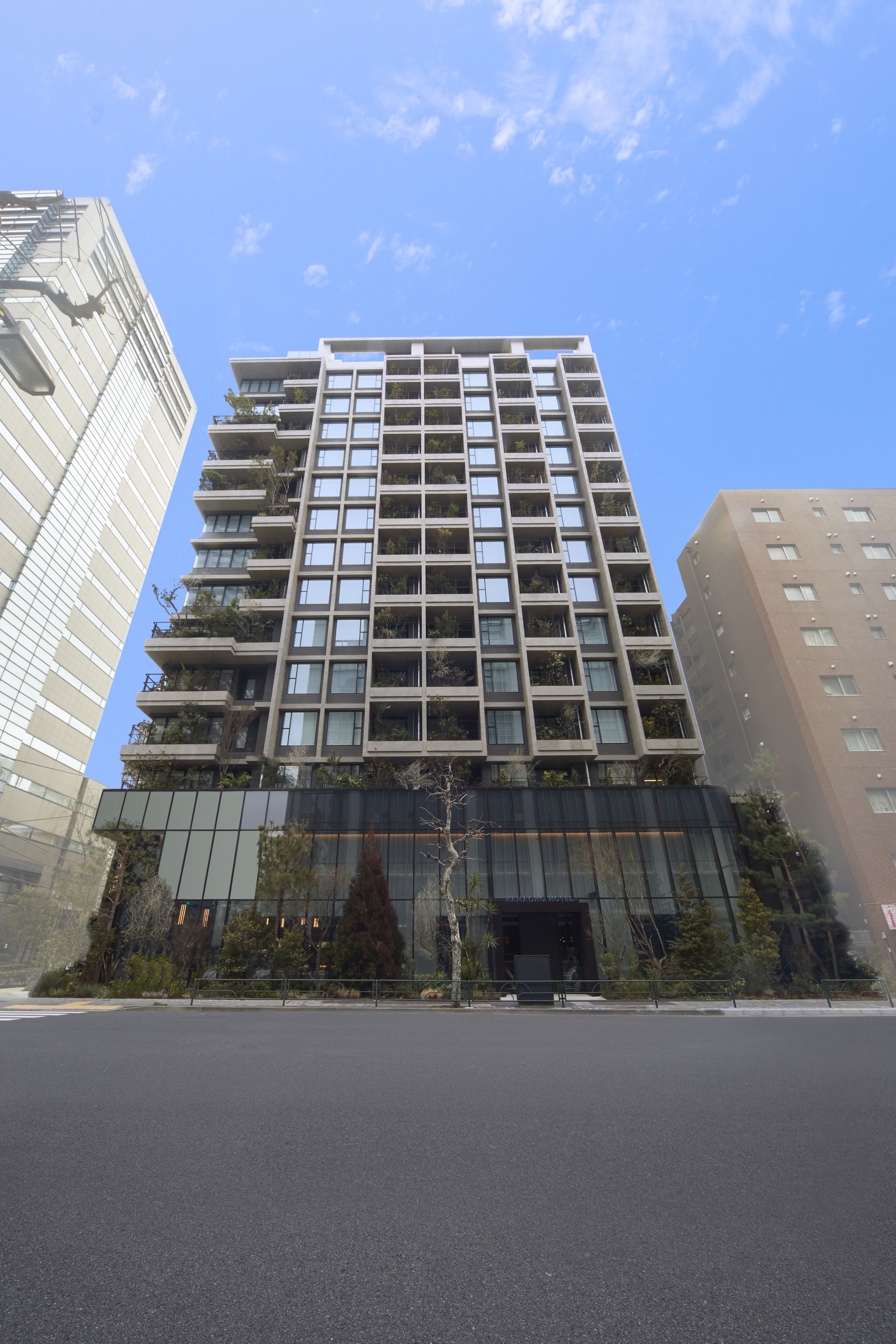 A multi-story building with a modern architectural design, featuring balconies and large windows.