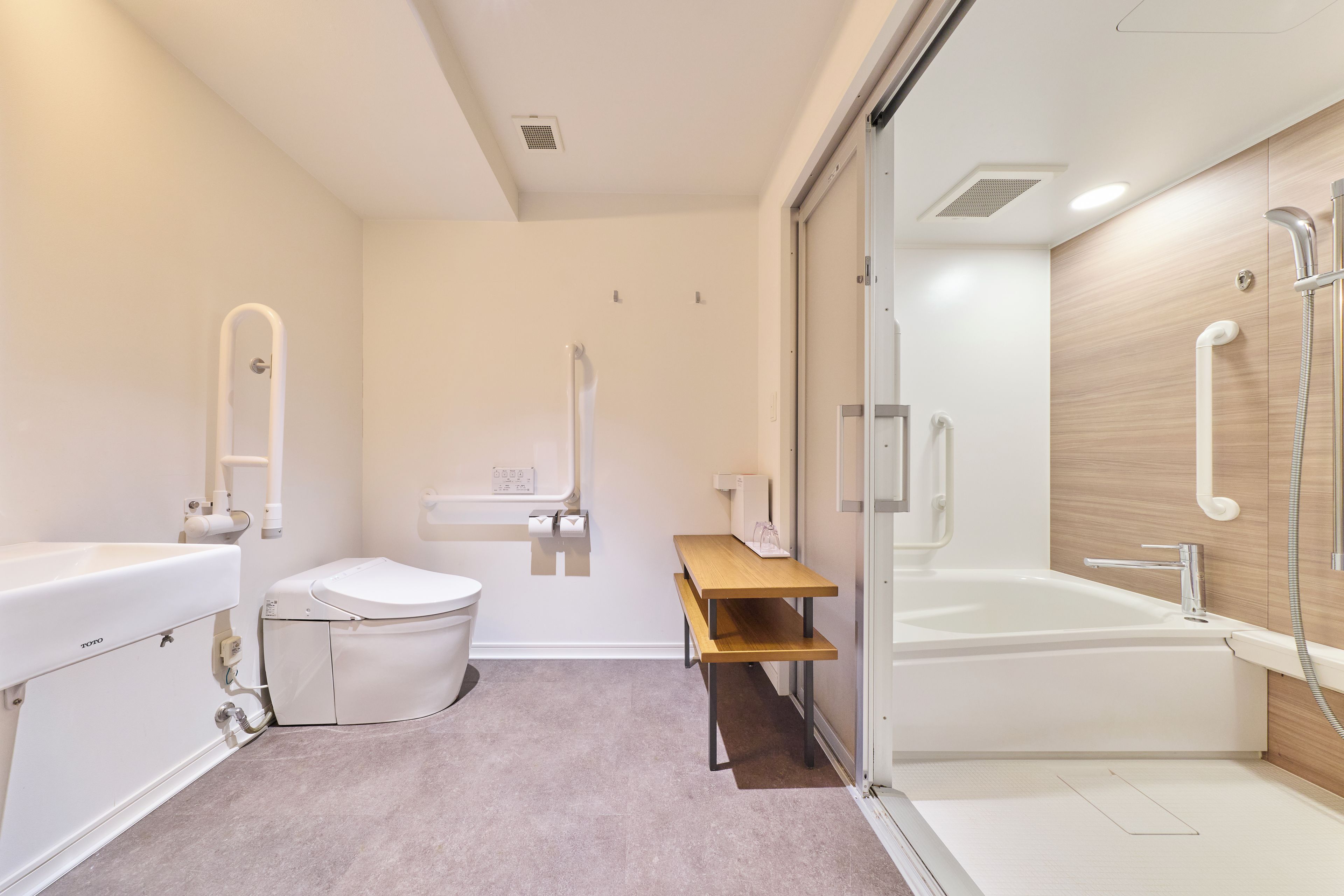 A modern bathroom with a toilet, sink, and bathtub.