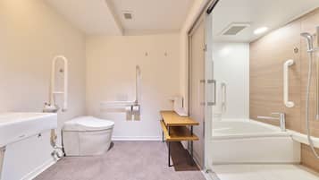 A modern bathroom with a toilet, sink, and bathtub.