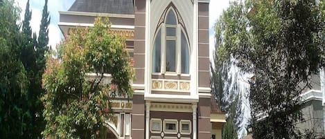 A historic building with a prominent central window and decorative facade.