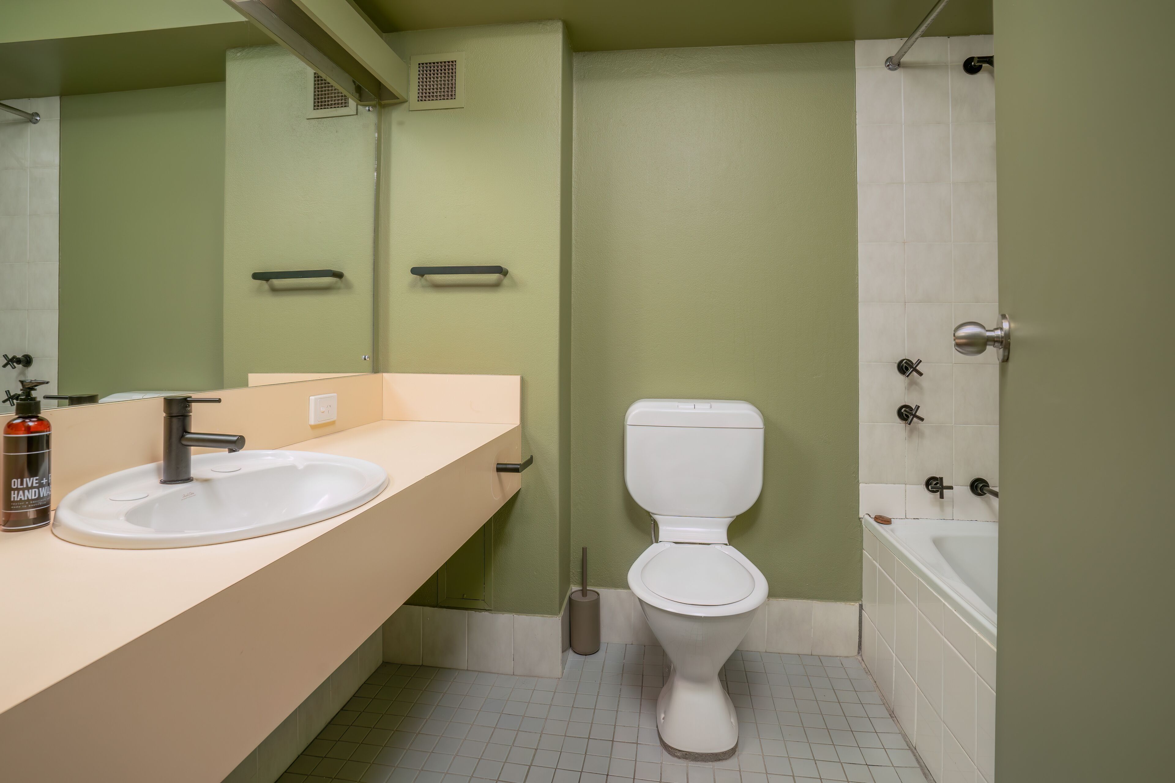 A bathroom with a sink, toilet, and bathtub.
