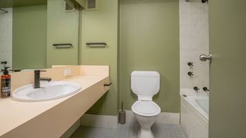 A bathroom with a sink, toilet, and bathtub.