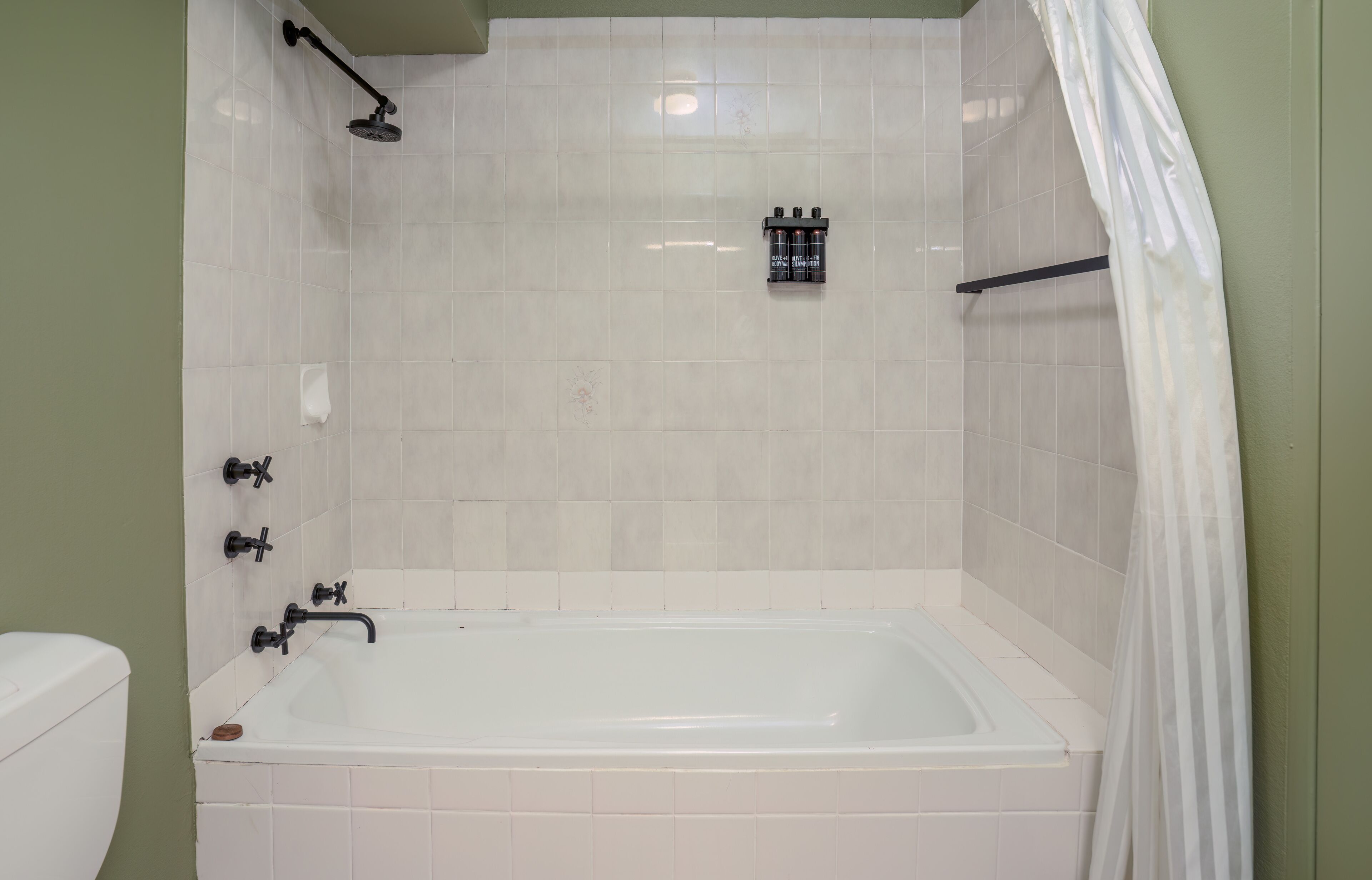A bathroom with a bathtub, a shower, and a toilet.