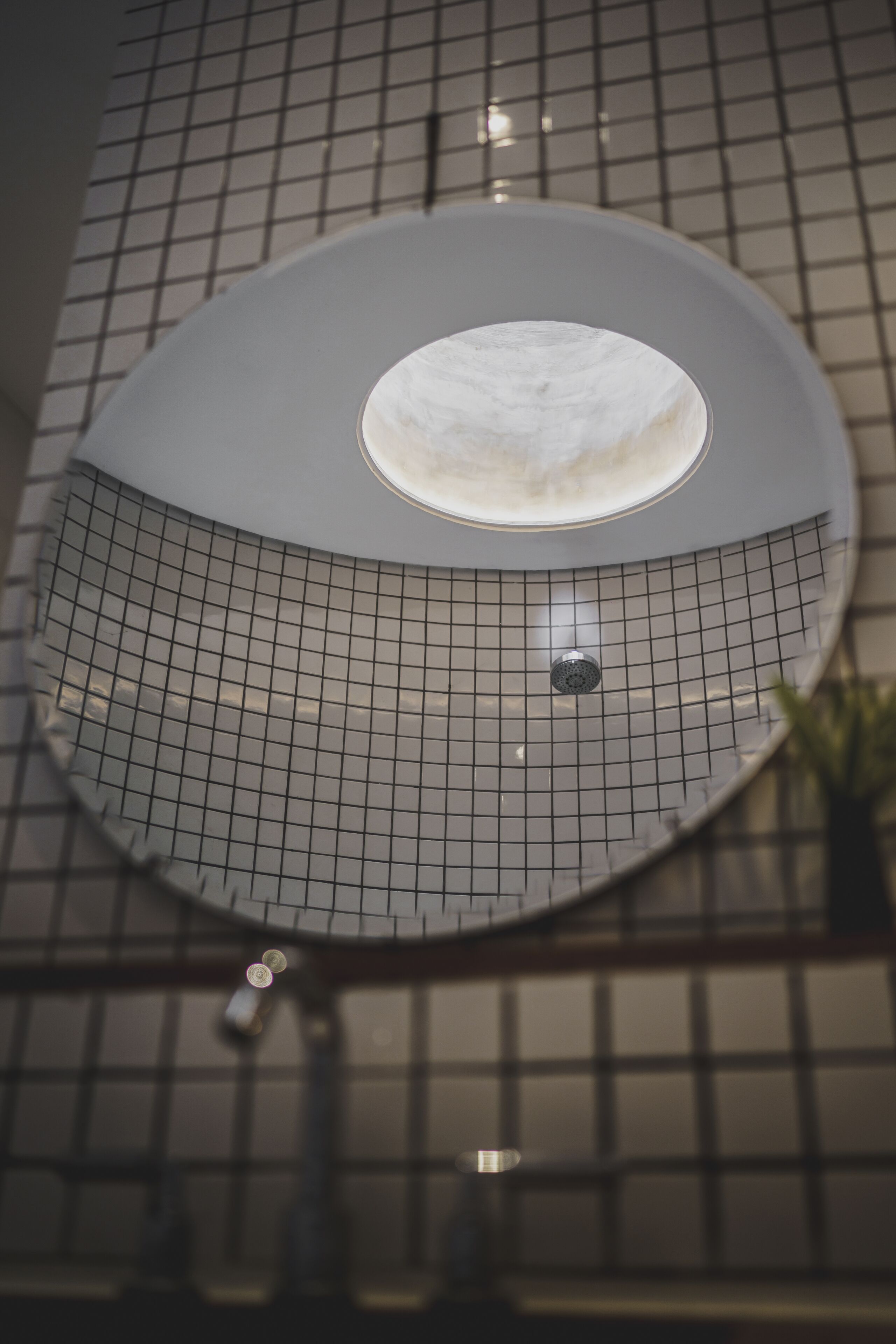 A circular skylight with a central white circular opening, surrounded by a grid pattern.