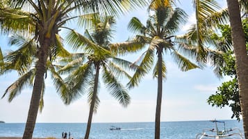 On the beach, black sand, beach towels