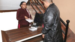 A reception desk with a computer monitor, telephone, and a sign labeled "RECEPTION". - Sitapaila Homestay and Apartment (Nagarjun)