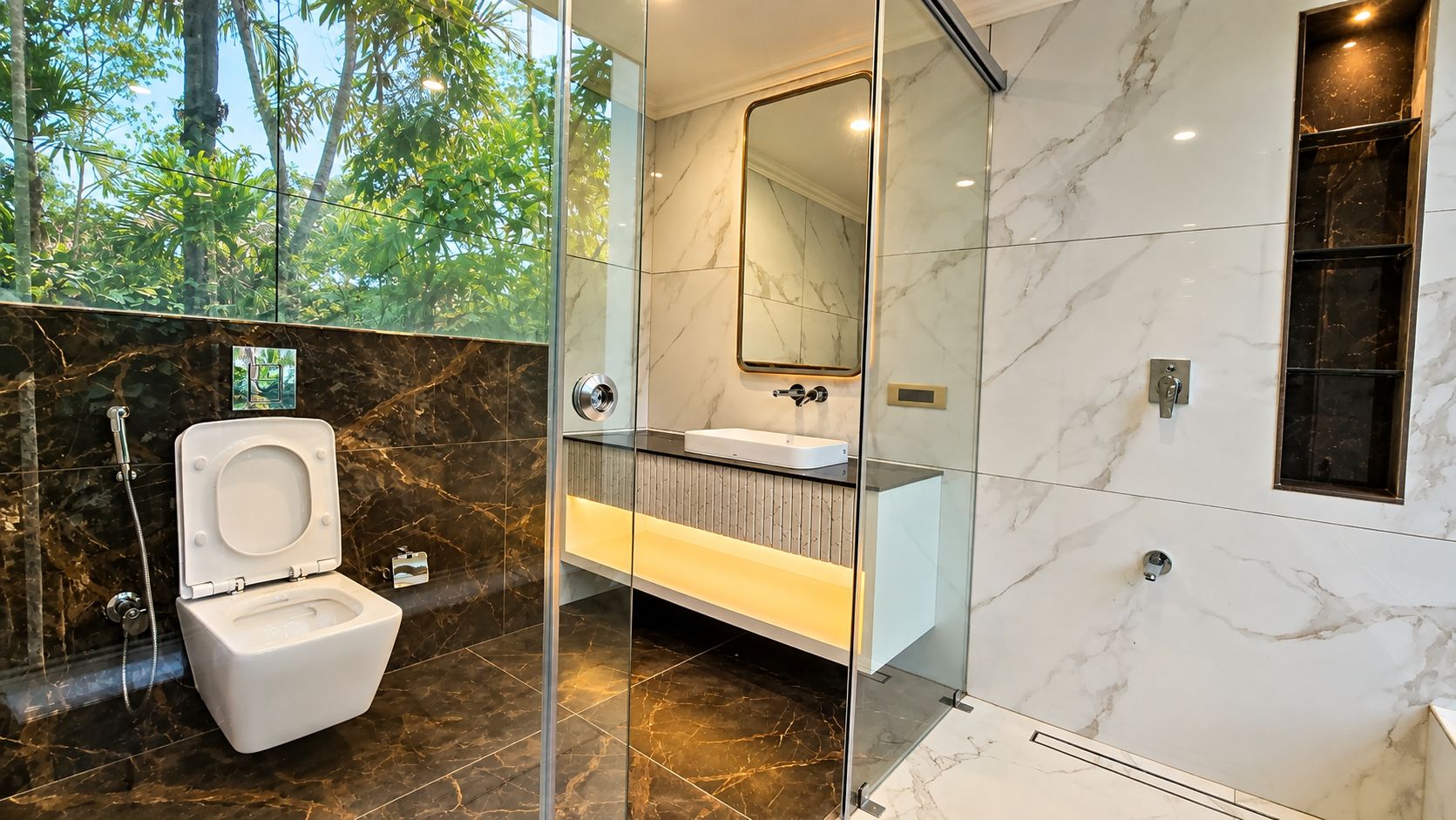 A modern bathroom with a glass-enclosed shower, a white toilet, and a vanity with a mirror.