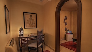 A traditional room with a desk, chair, and a framed portrait on the wall. - Le Riad Hotel de Charme (Cairo)