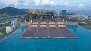 A rooftop infinity pool with lounge areas and a restaurant named 'Skylight'. - Central Luxury Ha Long Hotel (Bai Chay)