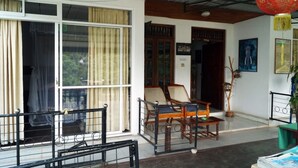 A traditional room with a large sliding door, wooden furniture, and a red lantern. - Ella City Reach Hostel (Ella)