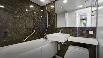 A modern bathroom with a bathtub, a sink, and a toilet.