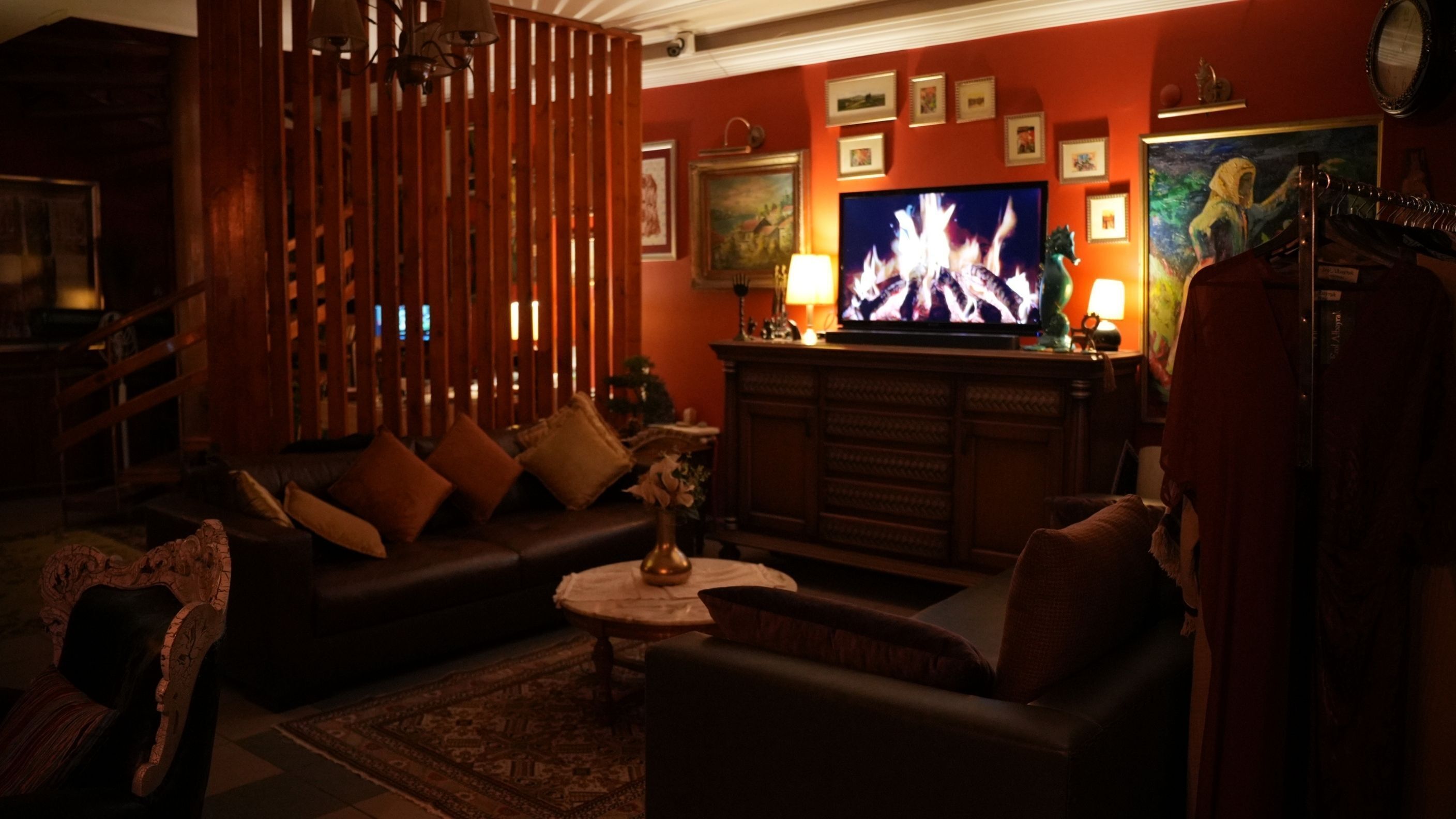 A cozy living room with a fireplace, a television, and a sofa.