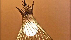 A unique, modern chandelier with multiple thin rods converging towards a central light source. - Clos de la Gourmandière (Saint-Lothain)