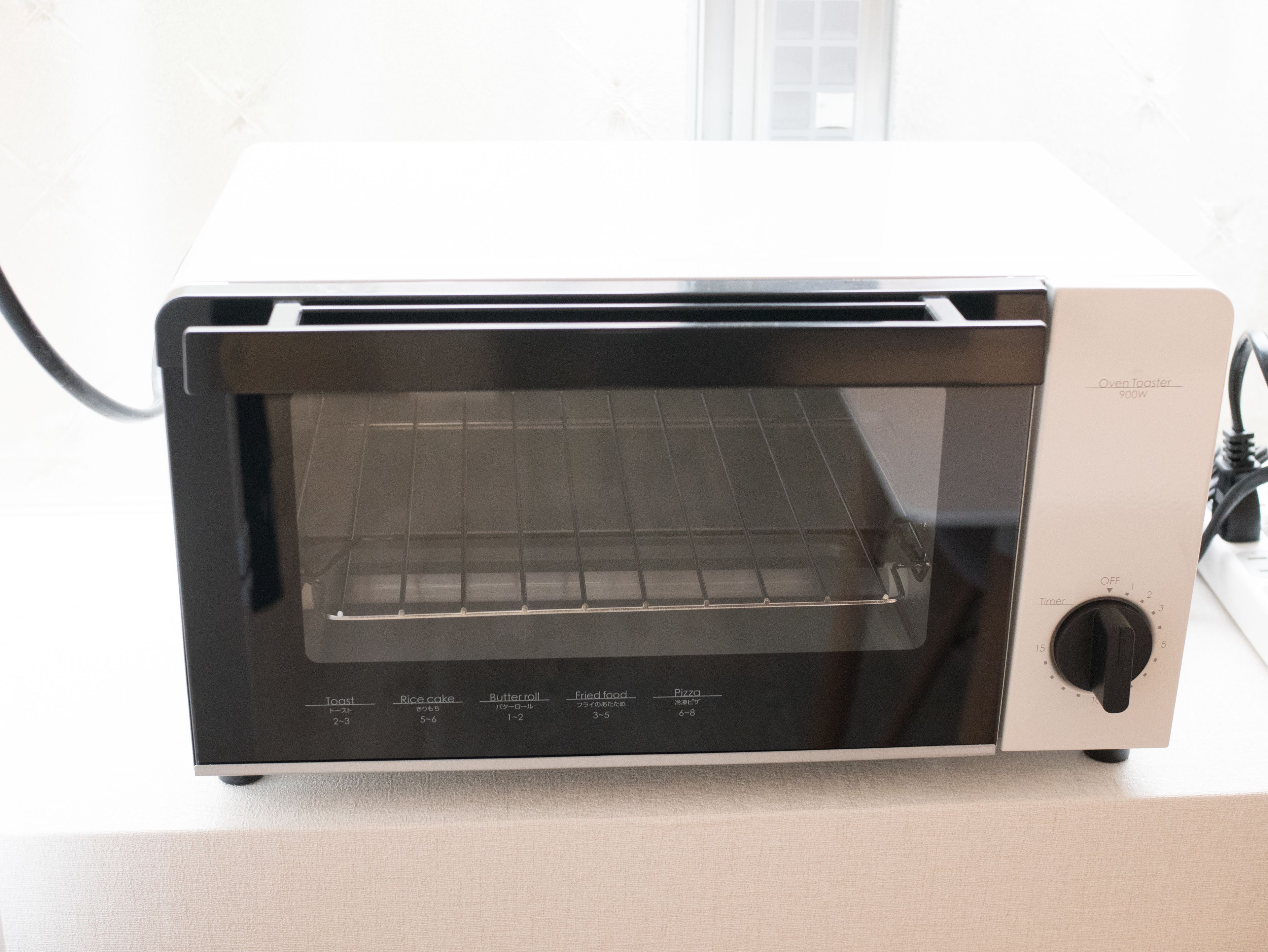 A toaster oven with a digital display and multiple cooking settings.