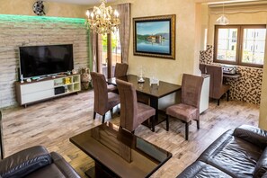 Deluxe Apartment, 3 Bedrooms, Sea View | Living room | LCD TV