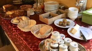 A buffet table with various food items and condiments. - Cascina Bosco Gerolo (Rivergaro)