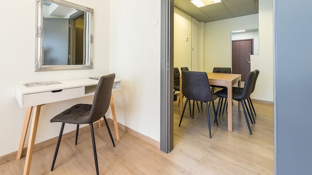 A room with a white desk, a mirror, and a dining table with chairs. - Athens Welcome Suites Apartments (Athens)