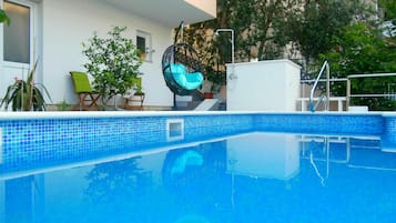 Seasonal outdoor pool, open 9:00 AM to 8:00 PM, pool umbrellas