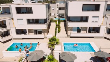 Seasonal outdoor pool, open 9:00 AM to 9:00 PM, pool umbrellas