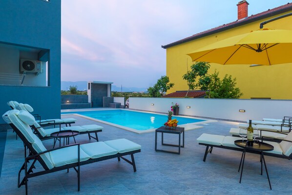 Seasonal outdoor pool, pool loungers