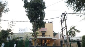 A hotel entrance with a gated driveway, a signboard, and a building in the background. - OYO 27718 Viva Destinations (Gurugram)