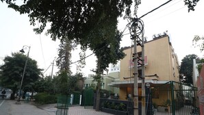 A building with a gated entrance, a paved sidewalk, and a street lamp. - OYO 27718 Viva Destinations (Gurugram)