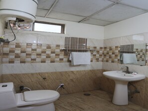 A bathroom with a toilet, sink, and shower. - OYO 19664 Aman Hotel (Noida)