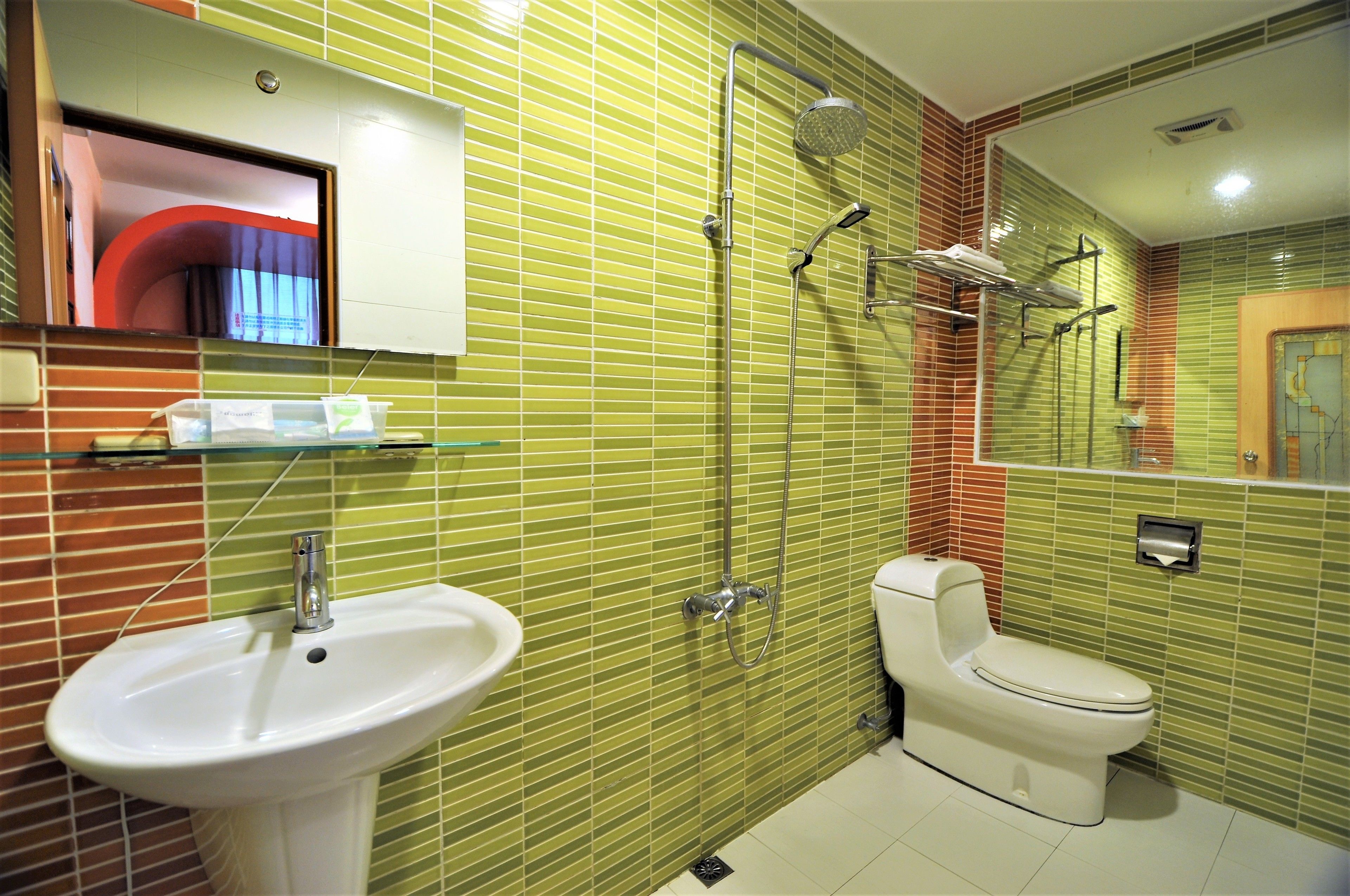 A bathroom with a sink, toilet, and shower.