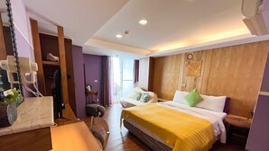 A hotel room with a bed, bedside table, chair, and a desk with a computer. - Tz Shin Resort Hostel (Hengchun)
