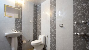 A bathroom with a white sink, toilet, and shower area. - OYO 22039 Hotel Bkc Grand (Mumbai)
