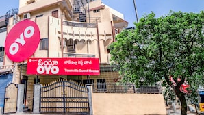 A building with a prominent red sign reading "OYO Townvilla Guest House" and a large red logo. - CAPITAL O 15141 Townvilla Guest House (Hyderabad)