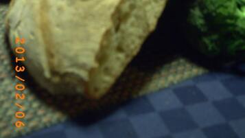 A loaf of bread on a table with a checkered tablecloth.