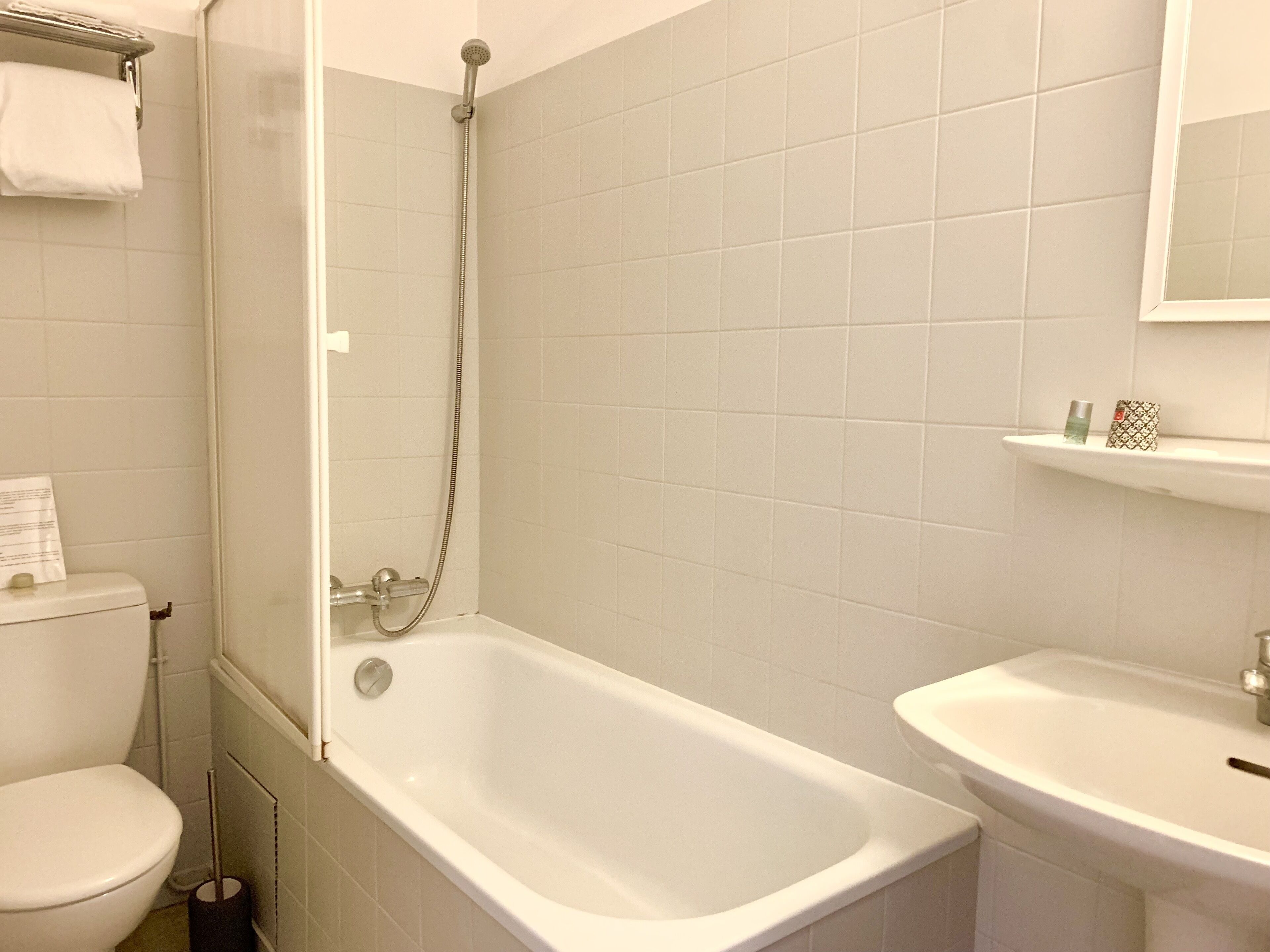 A bathroom with a bathtub, toilet, and sink.