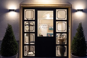 A hotel entrance with a terrace suite and breakfast.
